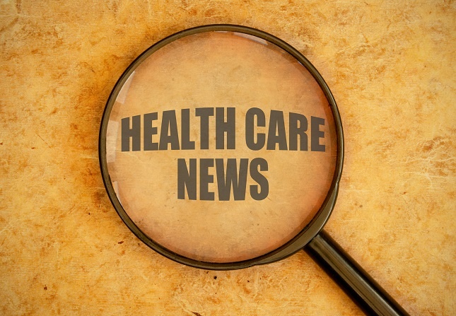 Magnifying glass magnifying the words: Health Care News