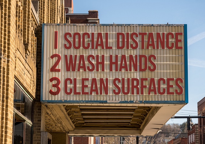 Sign that says, "1 Social Distance, 2 Wash Hands, 3 Clean Surfaces"