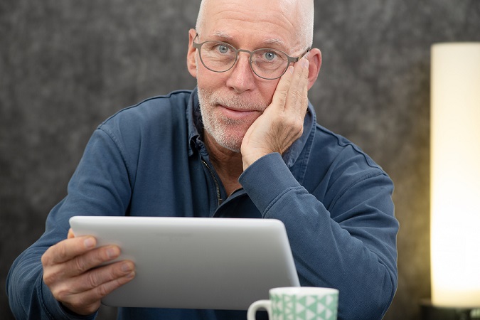 Senior man using an electronic tablet