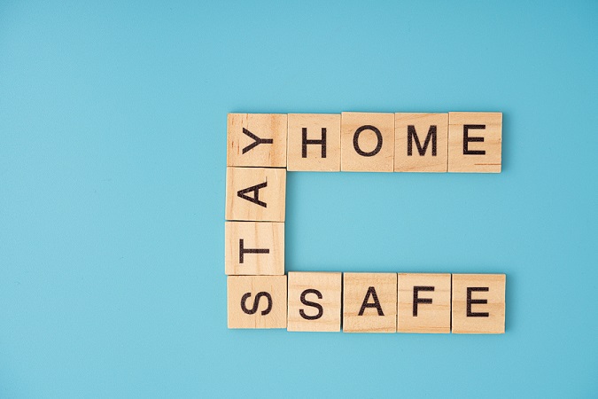 Scrabble letters that say, "stay, home, safe"